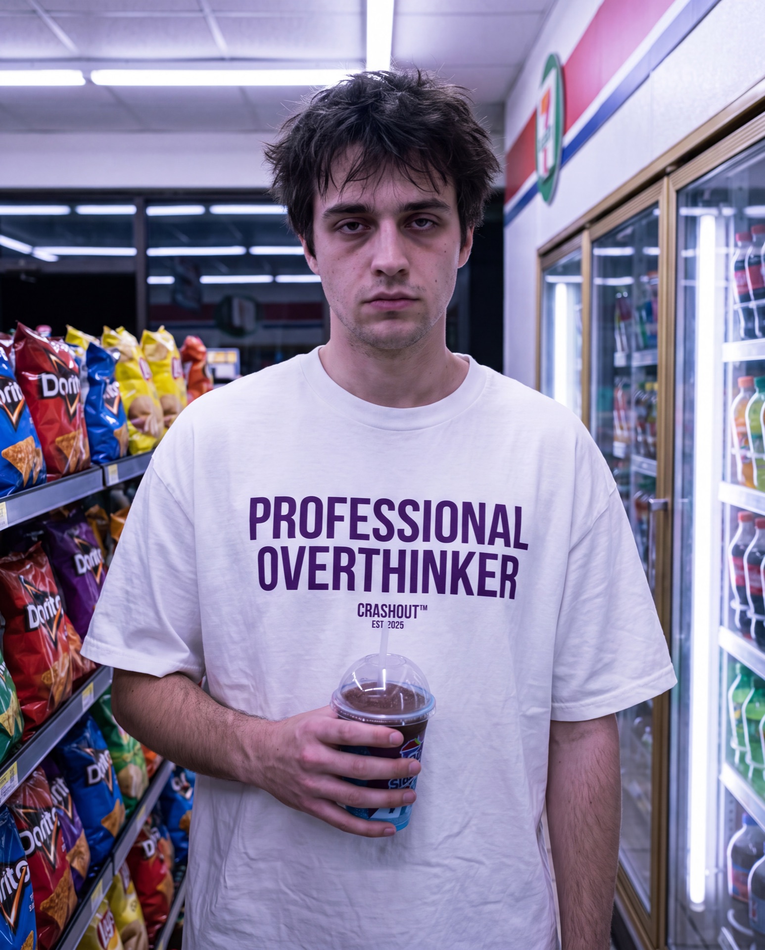 Model in a fluorescent convenience store at 3am wearing a Professional Overthinker tee